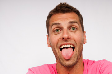Young attractive man shows his tongue © petrdlouhy