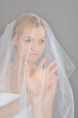 young beautiful bride covered in veil