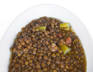 Lentil soup on white dish.