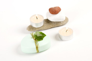 Fototapeta na wymiar green soap, candle and colored stones