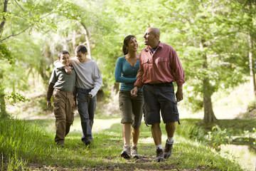 Hispanic family walking along trail in park