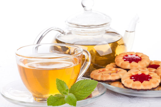 Cup of tea  with mint and pastries.