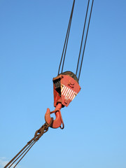 red crane arm on blue sky, industrial jib details