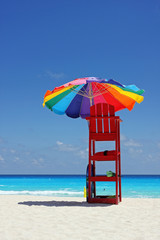 Colorful umbrella on white Caribbean beach