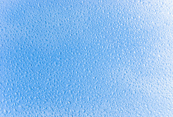 Water drops with blue sky on background