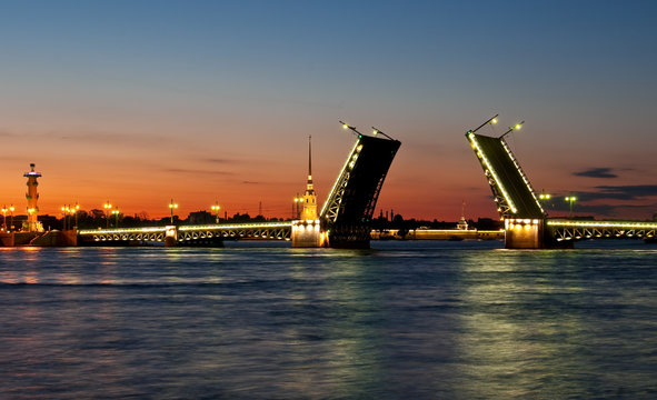Raised Palace bridge at night in St-Petersburg, Russia