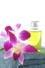 bottles of essential oil with .orchid on blue towel