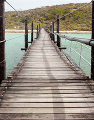 Long Wooden Suspension bridge over a lagoon