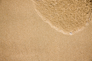Wave on clear sand beach
