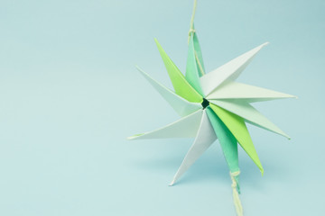 star shaped paper origami tied by a thread at ends