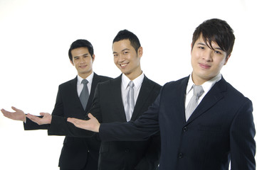 Three young businessman posing-welcome gesture