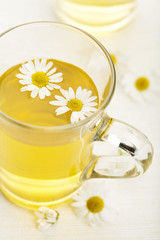 cup of herbal tea with chamomile flowers