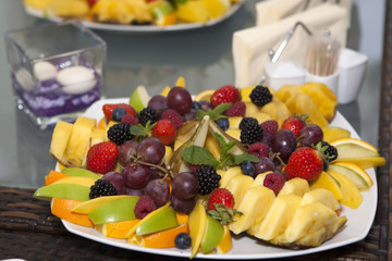 raw tropical fruits served on white plate