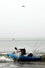 Kayaker surprised by a wave