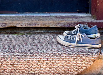 Blue Tennis Shoes on Welcome Mat