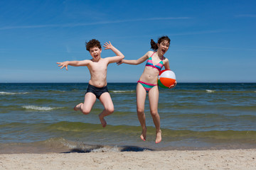 Kids jumping on beach