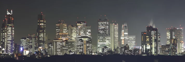 Fotobehang Tokyo bij nachtpanorama met verlichte wolkenkrabbers © Achim Baqué