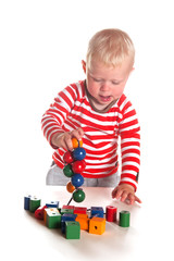 Baby boy is playing with wooden beads