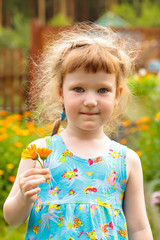 Cute little girl with the flowers in her hand