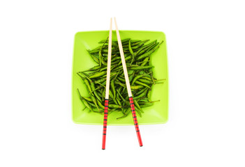 Hot peppers with chopsticks and plate
