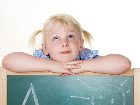 Cute blond girl is learning the Alphabet