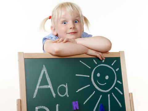 Cute girl is happy to learn the Alphabet at school
