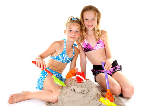 two young girls in beach wear over white background