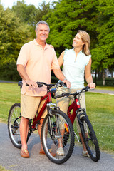 seniors couple biking