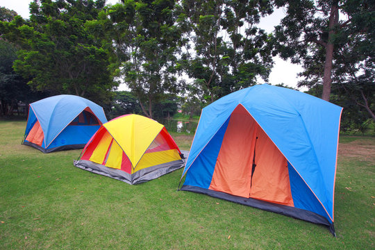 Row of tents for camping on grass