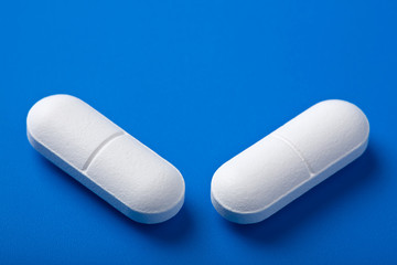 white pills over blue