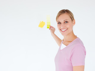 Smiling woman painting a room