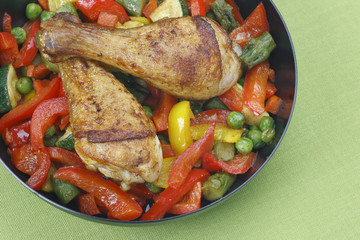 Chicken legs with fried vegetables