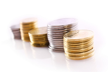 Many coins in column isolated on white