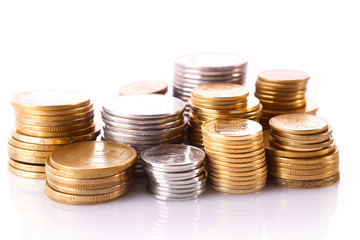 Many coins in column isolated on white