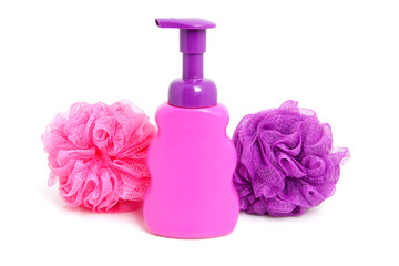 Obraz na płótnie Canvas Pink soap bottle with purple sponge over white background