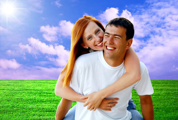 Young love couple smiling under blue sky
