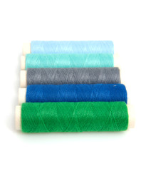 blue and green sewing gear over white background