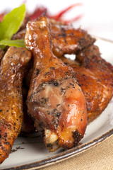 homemade smoked  chicken drumstick on a plate, shallow DOF