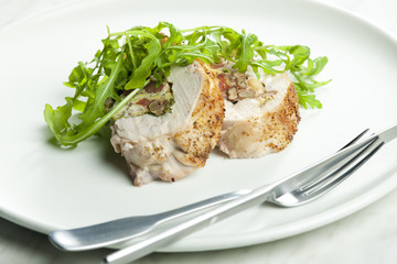 pork roll filled with sausages, eggs, almonds and ruccola