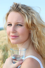 Closeup of woman holding glass of water