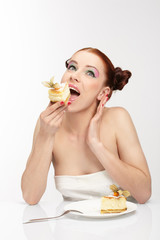 The beautiful young woman eat tasty cake