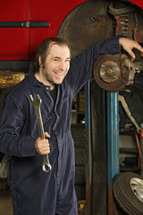 Obraz na płótnie Canvas Crazy mechanic fixing the brakes