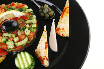 small roast meat chunks on black