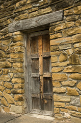 Stone wall with old wood  door