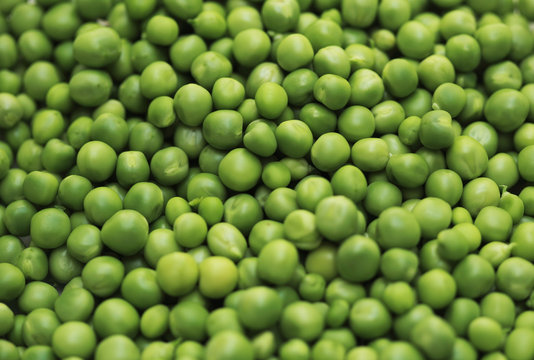 Shelled fresh ripe green peas background