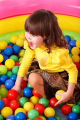 Fototapeta na wymiar Child in group colourful ball.