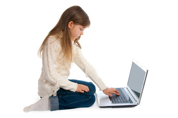 Fototapeta premium The sitting little girl with the laptop