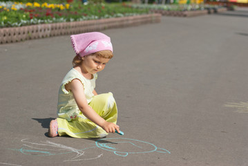 A little girl draws