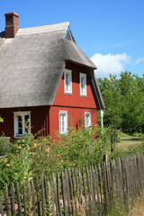 Fototapeta na wymiar House with thatched roof and garden