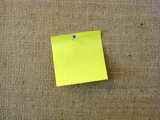 Yellow note paper with pin